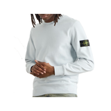 STONE ISLAND LOGO APPLIQUED GARMENT-DYED COTTON SWEATER IN BLUE